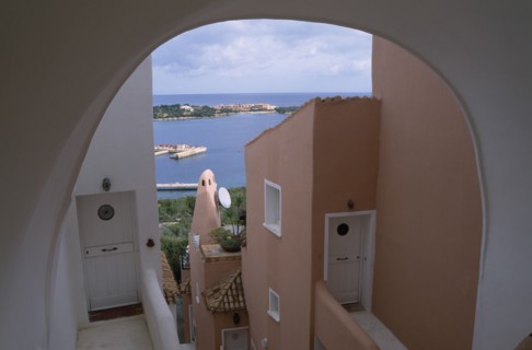 ITALY, Sardinia, Costa Smeralda, "Porto Cervo brightly painted apartment alley way, looking out
