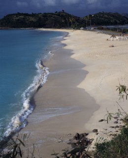 WEST INDIES, Antigua, Darkwood Bay, View along quiet sandy beach and bay with a few people