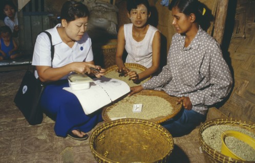 MYANMAR, Mandalay, Sexual health worker discussing the use of condoms with local women in rural