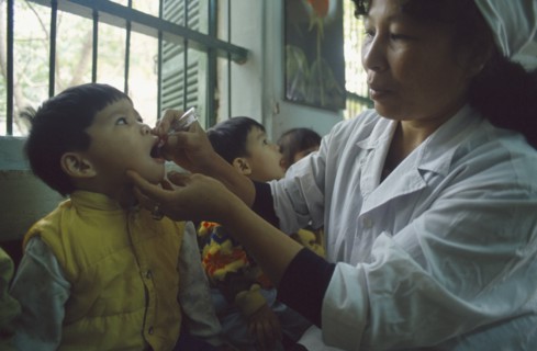 VIETNAM, North, Hanoi, Primary school children receiving oral polio immunization from nurse.