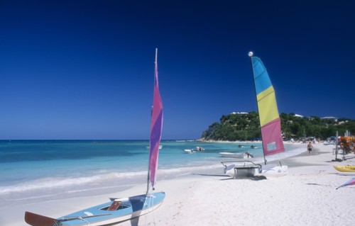 WEST INDIES, Antigua, Long Bay, "Semi circular bay beside quiet beach, boats with colourful sails