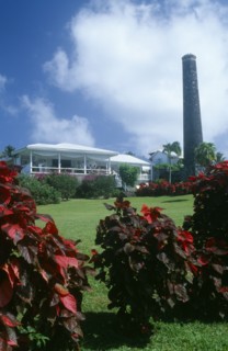 WEST INDIES, St Kitts, Rawlins Plantation Inn, Exterior with people on white painted balcony and