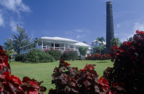 WEST INDIES, St Kitts, Rawlins Plantation Inn, Exterior with people on white painted balcony and