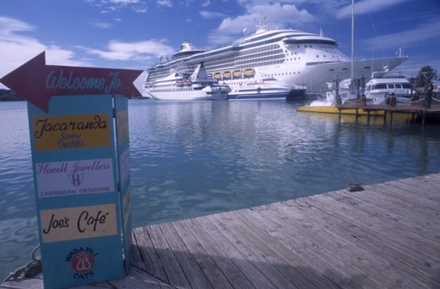 WEST INDIES, Antigua, St Johns, St Johns Harbour.  Wooden jetty in the foreground with painted sign