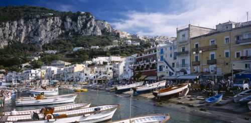ITALY, Campania, Capri, Marina Grande.  View over moored boats in harbour lined with colourful