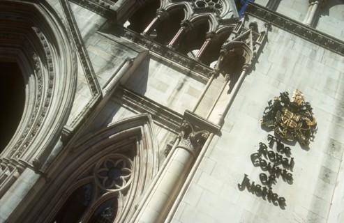 ENGLAND, London, Royal Courts of Justice. View looking up at the building with the crest displayed