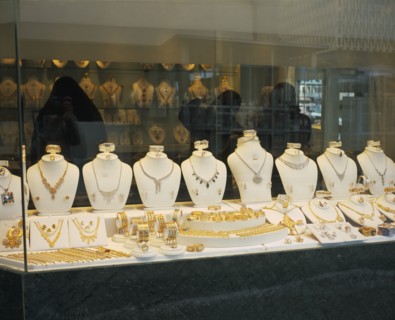 KUWAIT, Kuwait City , "Gold Souq.  Three women in black Burqa inside jewellery shop, seen through