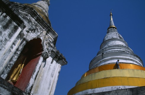 THAILAND, North, Chiang Mai, Wat Chedi Luang. Statue of standing Buddha in an alcove  beside a