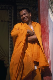 THAILAND, North, Chiang Mai, Wat Tung Yu temple hall with Buddhist monk laughing