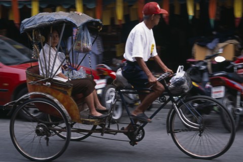 THAILAND, North, Chiang Mai, Cyclo in motion with passenger.