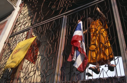 THAILAND, North, Chiang Mai, Wat Saen Fang.  Metalwork partition with monk climbing inside to