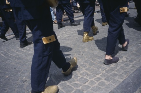 BELGIUM, West Flanders, Bruges, Parade of people wearing golden Clogs in Steenstraat during