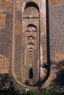 ENGLAND, West Sussex, Haywards Heath, Balcombe. View through line of arches under railway viaduct.