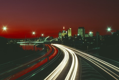 AUSTRALIA, Queensland, Brisbane, The south east freeway approaching the city illuminated at night