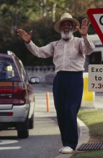 BERMUDA, Hamilton, Local character Johnny Barnes at roadside laughing and throwing his hands up in