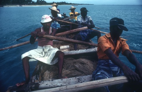 SRI LANKA, Industry, Fishing, Local fishermen laying drag nets from small rowing boat