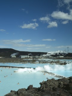 ICELAND, Near Grindavik, Blue Lagoon, View over steaming waters with bathers toward Svartsengi