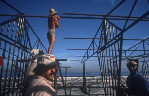 CUBA, Havana, Construction workers erecting metal framework for stalls during the Carnival on the