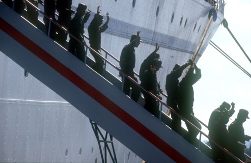 CUBA, Military, Waving soldiers returning from Angola walking down the gangway from a ship