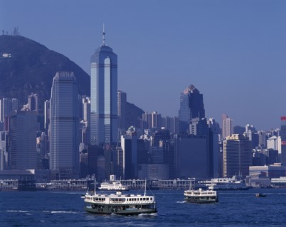 HONG KONG, Victoria Harbour, Star Ferries sailing away from the city skyline behind