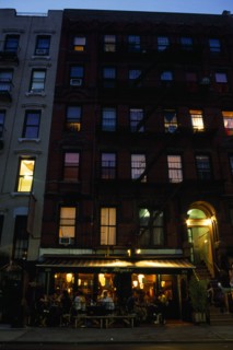 USA, New York, New York City, East Village. Cafe Mogador with tables and chairs under awning and