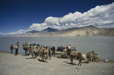 CHINA, Tibet, Transport, People with laden donkeys boarding a ferry to cross the Tsangpo river