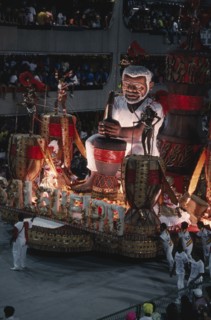 BRAZIL, Rio de Janeiro, Carnival float with large model of a man surrounded by dancers