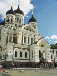ESTONIA, Tallinn, Alexander Nevsky Cathedral with people sitting on steps at the entrance.