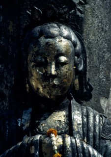 THAILAND, Bangkok, Wat Phra Kaew, Or Royal Palace. Close up detail of golden statue with floral