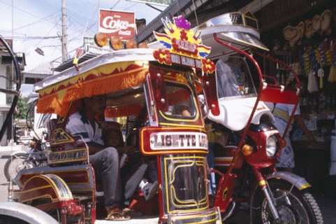 PHILIPPINES, Marinduque Island, Boac, Moriones Festival. Close up of brightly coloured tricycle