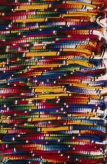 MEXICO, Chiapas, San Cristobal de Las Caras, Close view of layered pile of multicoloured textiles.