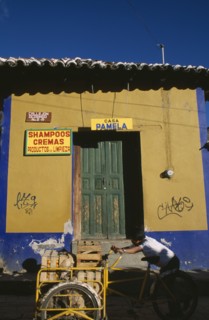 MEXICO, Chiapas, San Cristobal de Las Casas, Man pushing bicycle handcart stacked with crates of