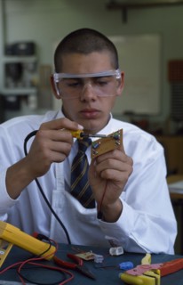EDUCATION, Secondary School, Science, Schoolboy in electronics class wearing protective glasses