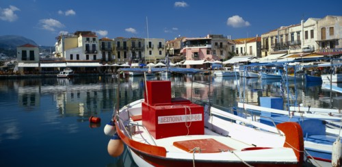 GREECE, Crete, Rethymno, "Venetian Port.  Colourful red, white and blue painted boats moored in