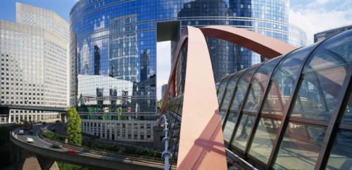 FRANCE, Ile de France, Paris, "La Defense.  Covered pedestrian bridge over busy road with circular,