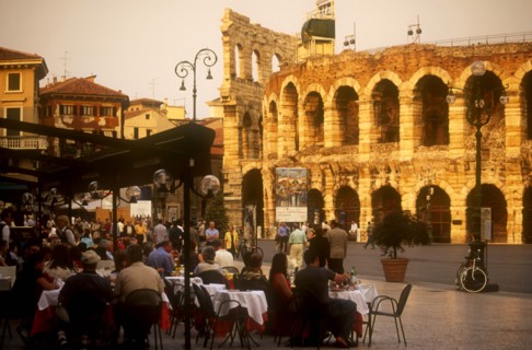 ITALY, Veneto, Verona, Piazza Bra.  Busy cafe with people eating and drinking at outside tables in