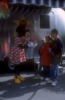 USA, Florida, Orlando, Walt Disney World. Minnie Mouse signing autographs for three children