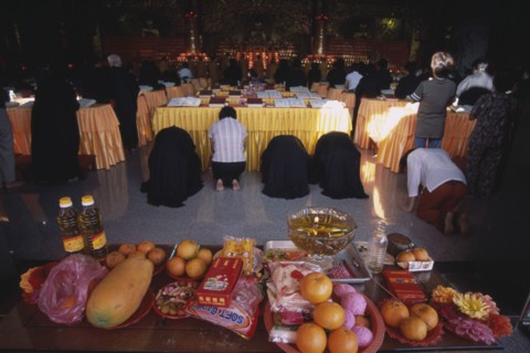 MALAYSIA, Penang, Kek Lok Si Temple, "Morning prayers in the main prayer hall. Kneeling worshippers