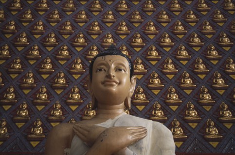 MALAYSIA, Penang, Georgetown, Wat Chayamangkalaram.  Detail of Buddha figure with hands crossed