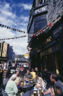 IRELAND, County Galway , Galway, People sitting outside Kings Head pub on Quay Street