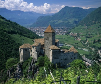 ITALY, Trentino Alto Adige, Bolzano, View over distant mountain village Karneid castle in
