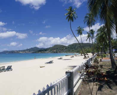 WEST INDIES, Grenada, Grand Anse Beach, View along empty sandy beach towards turquoise sea and