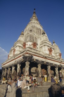 NEPAL, Religious, Bungamati Temple exterior with people gathered on the steps and golden spire