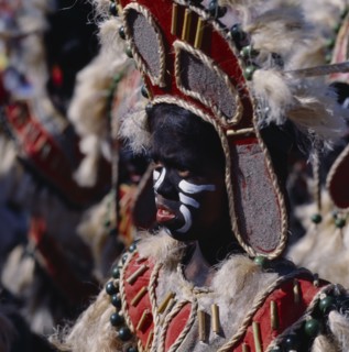 PHILIPPINES, Luzon, Manila, Young girl in costume at Ati-Atihan festival with a black painted face
