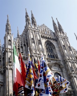 ITALY, Lombardy, Milan, Cathedral frontage with a souvenir stall selling flags and scarves