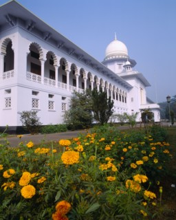 BANGLADESH, Dhaka, Supreme Court Building exterior facade with ornate white arches and orange