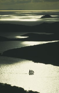 WEST INDIES, US Virgin Islands, St Thomas, Silhouette of two masted sailing ship with three sails