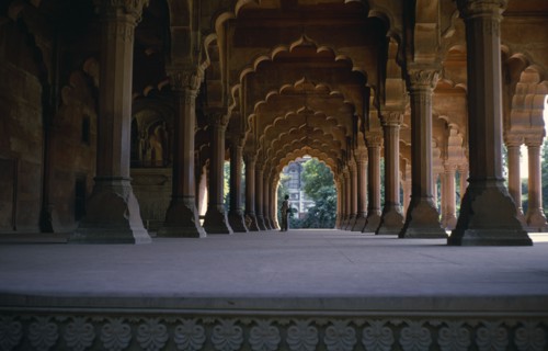 INDIA, Old Delhi, Red Fort, View down colonnade of ornate arches with couple standing at far end.