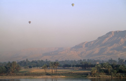 EGYPT, Upper Egypt, Luxor, Valley of the Kings with two hot air balloons over the river Nile at