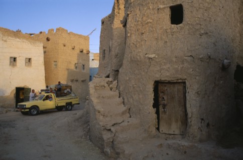 EGYPT, Western Desert, Siwa Oasis, Pick-up truck loaded with people and goods in street below Shali